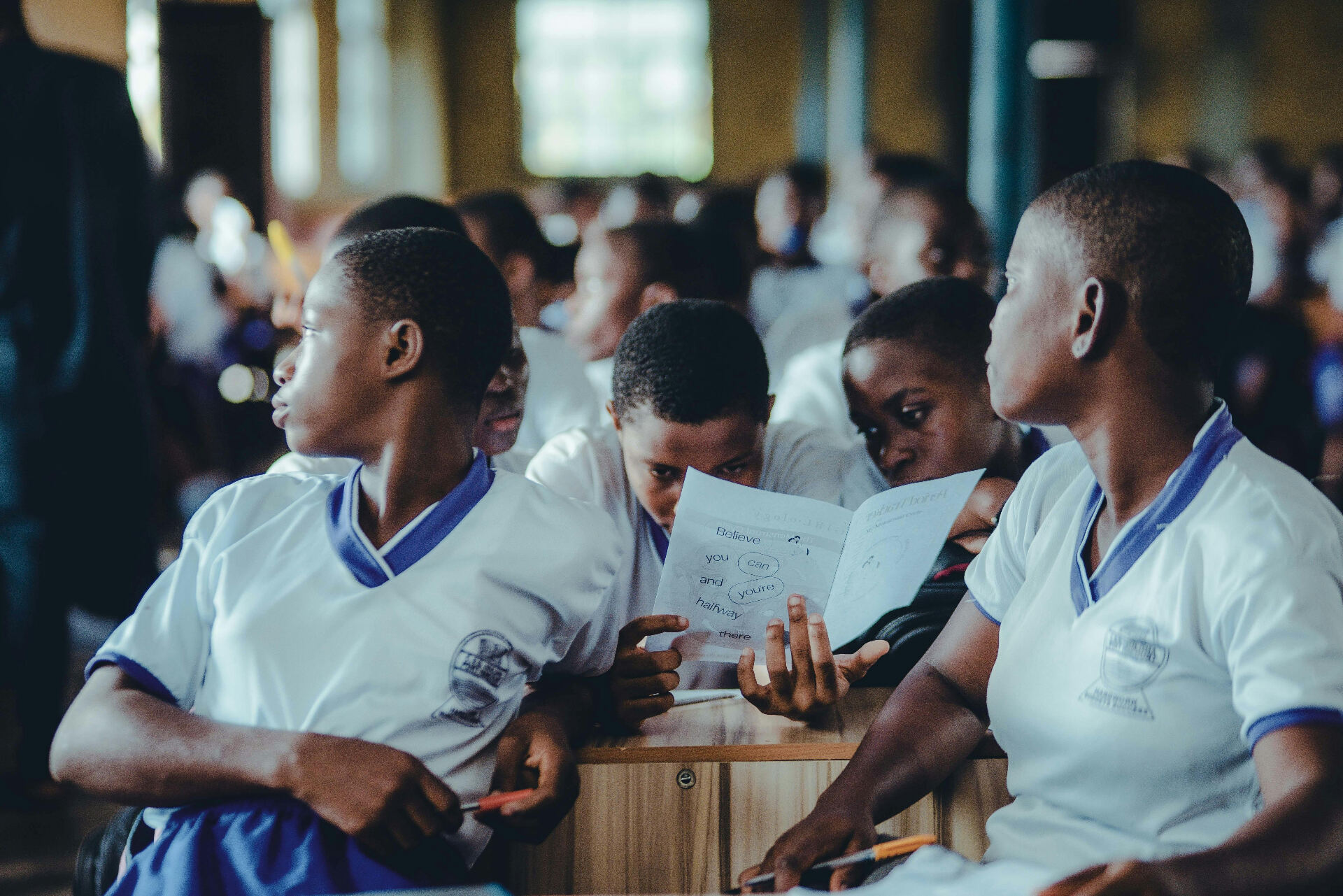 Kenyan students reading together in a classroom